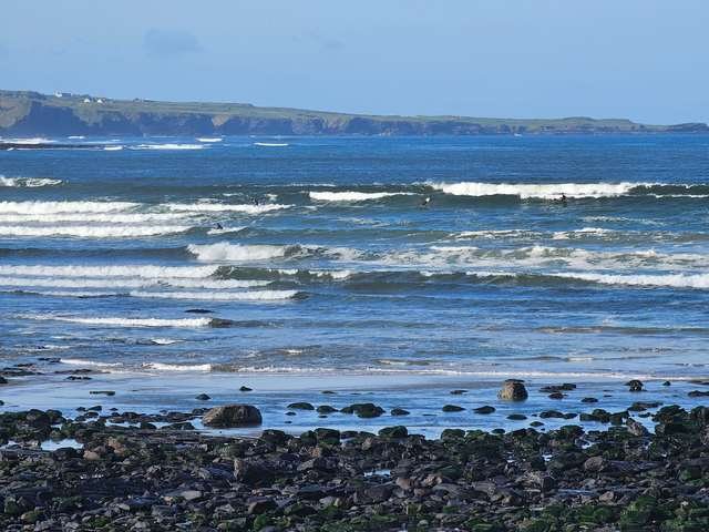 solid waves with plenty of people in the water